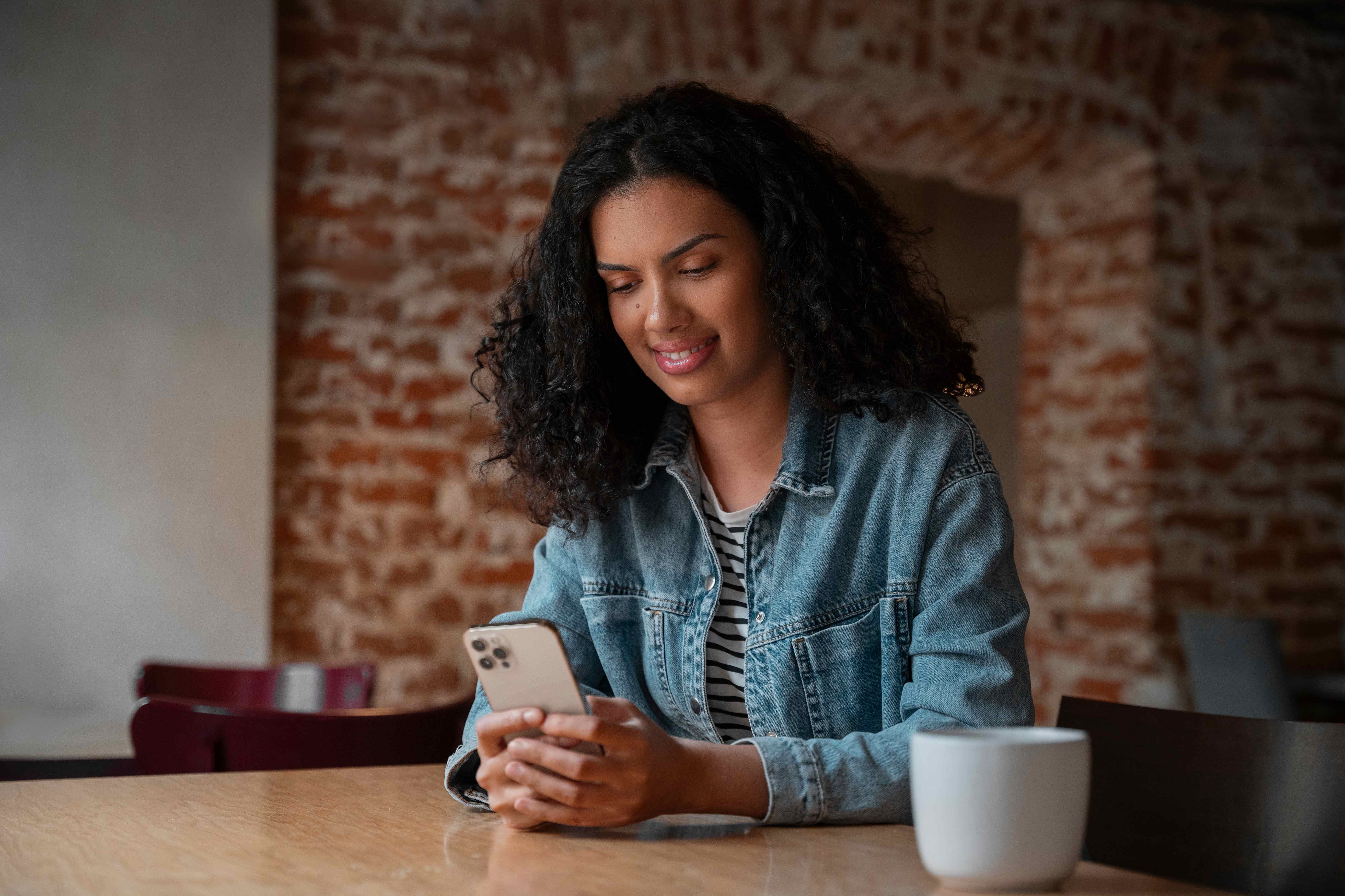 Woman using smartphone in cafe